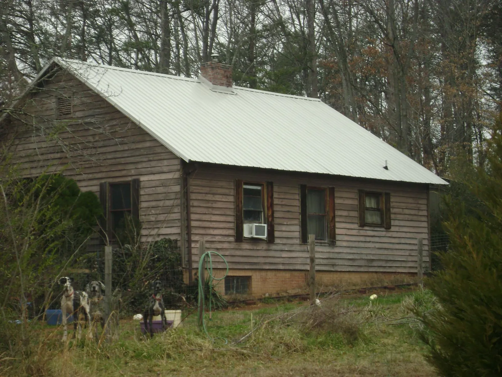 White metal roof on an old wood sided farmhouse, from a Metal Roof Installation job in Martin